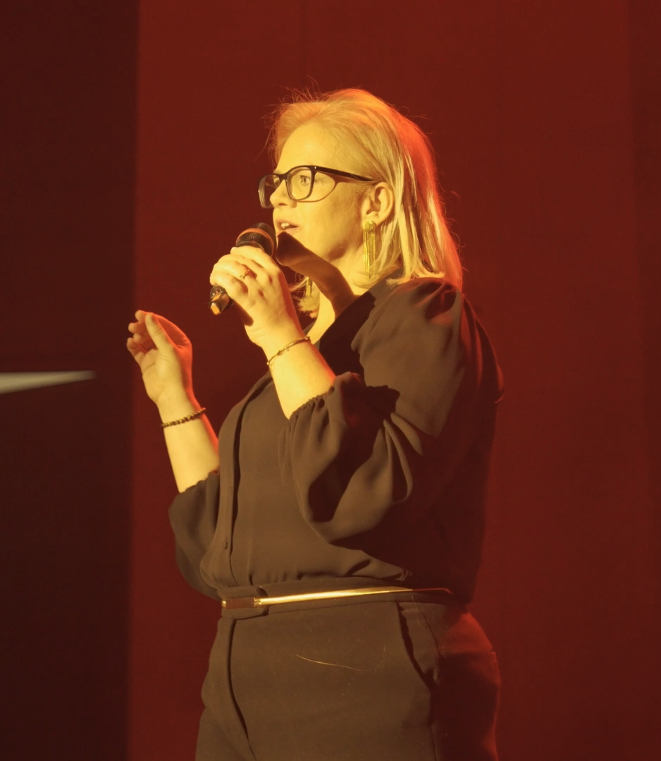 Catalina Hoffmann con el micrófono en el escenario, fotografía oficial en vivo